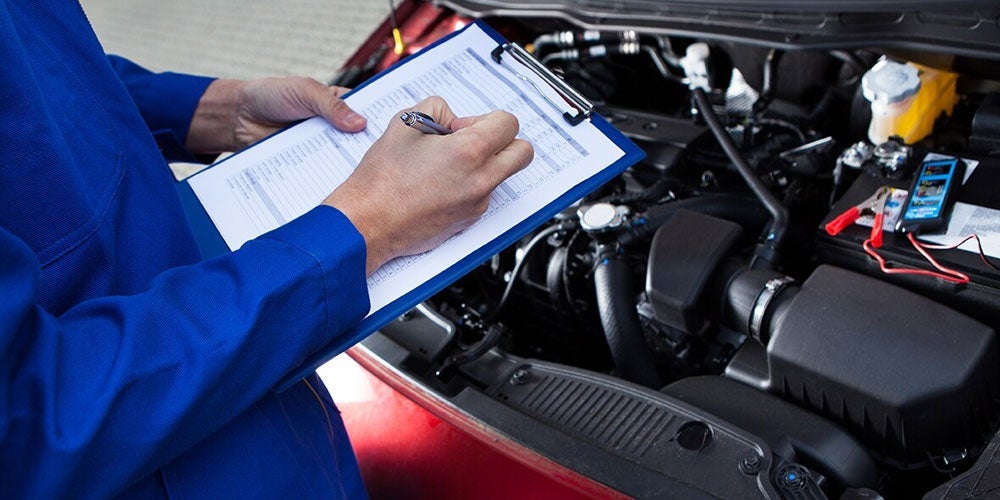 Technician performing a vehicle inspection